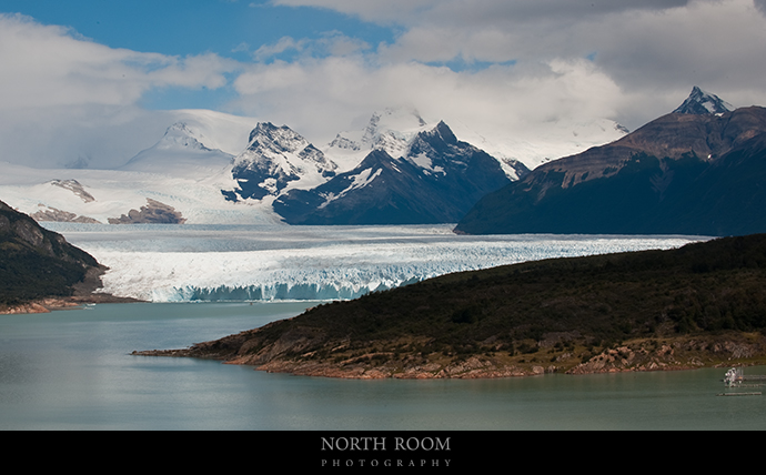 I took this from a hill about six miles away from the glacier.  If you look closely, the tiny black dot in the water just before the glacier is a passenger-carrying catamaran!